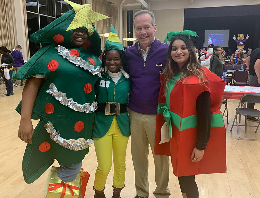Mariana, LSU Engineering students, and an administrator pose at Christmas event.