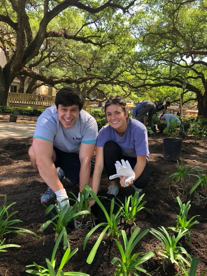 two students planting plants