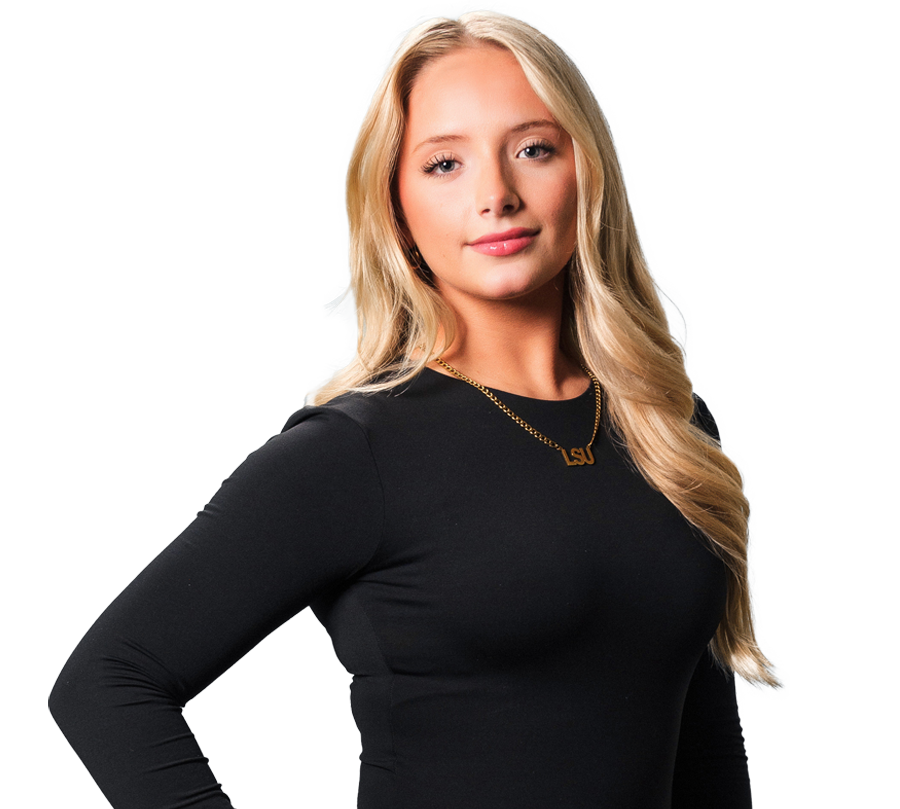 Mary Caroline is wearing a black shirt and holding her hand in the shape of an L