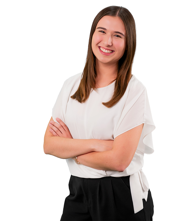 Macy McCalip is in a flowy white blouse. Her dark hair is shiny and smooth. She smiles at the camera.