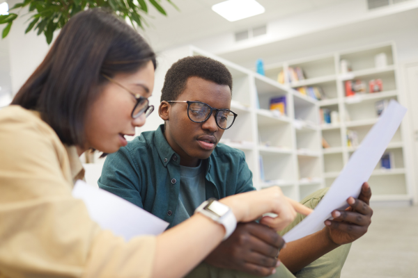 two students looking at a paper