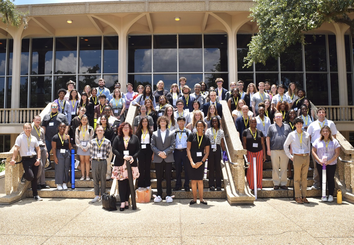 Large group of students standing on steps of building