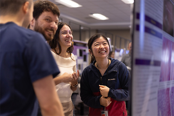 graduate students looking at posters